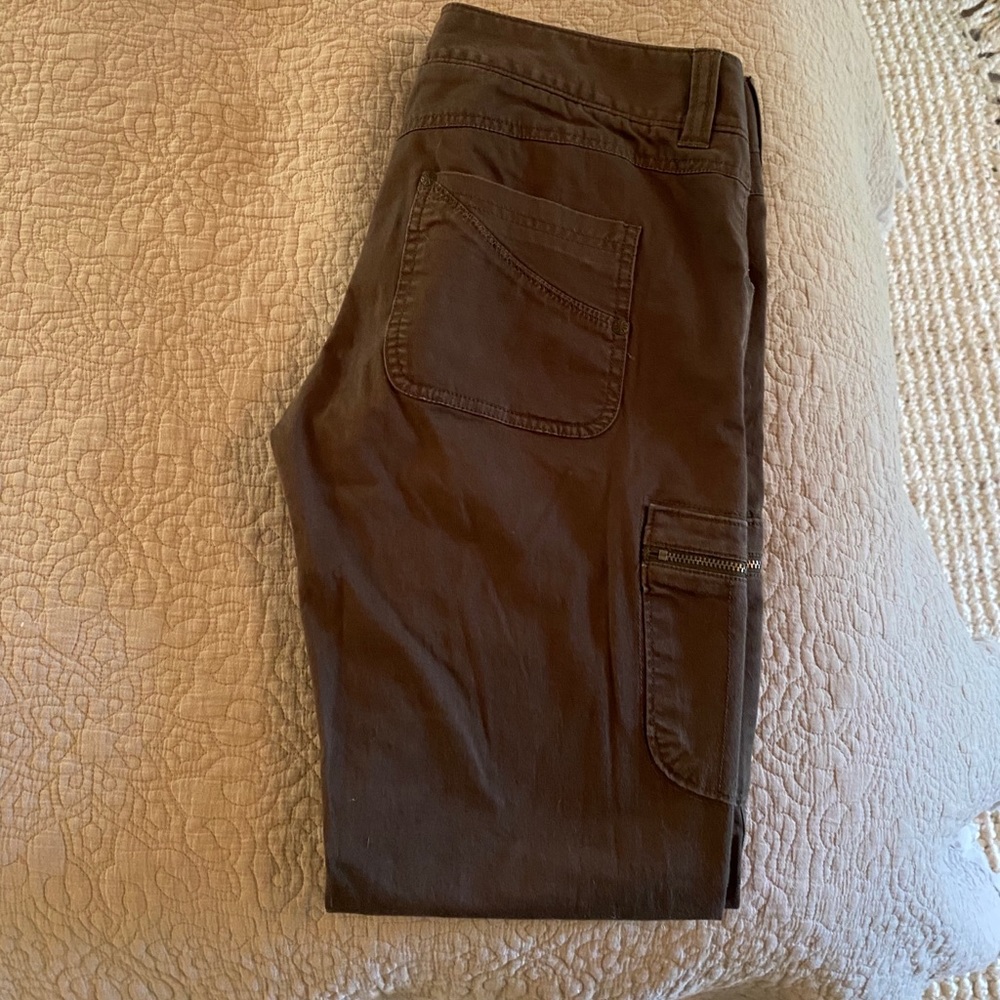 Olive green jeans with zipper pockets on the side